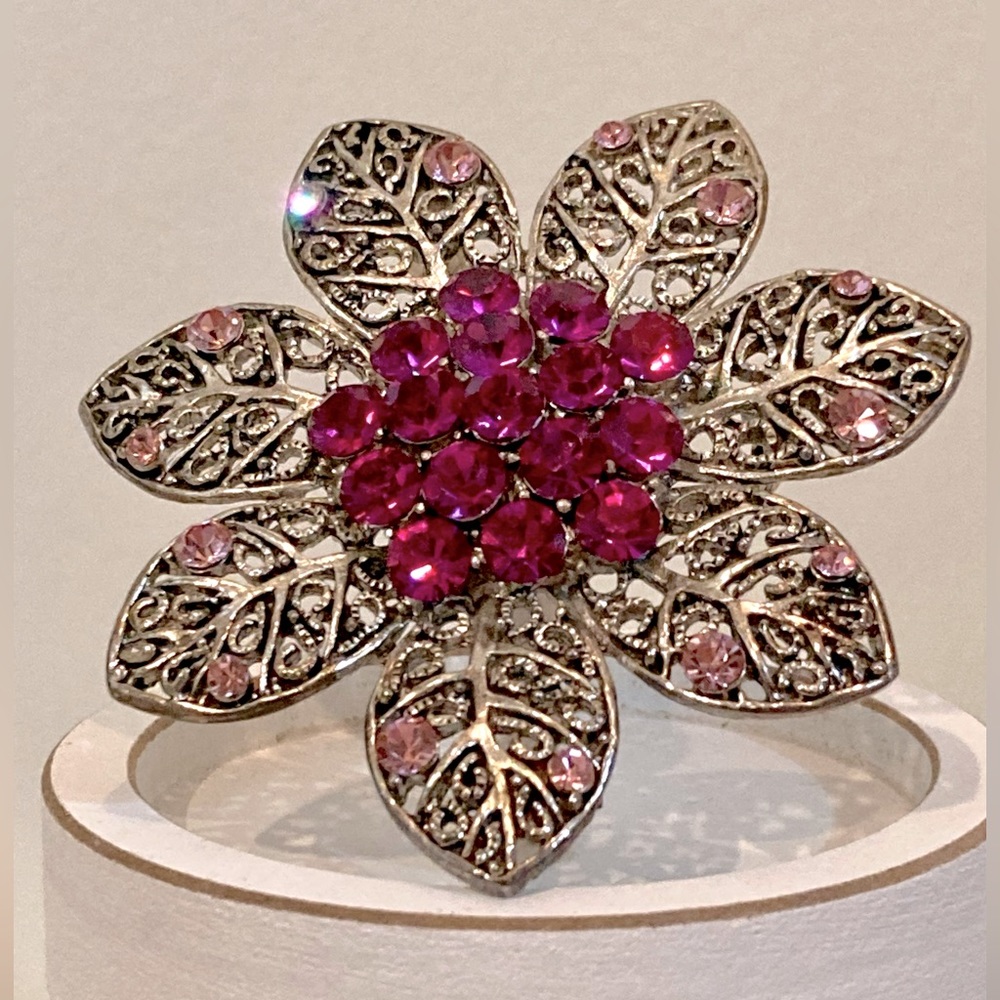 Antiqued silver tone flower brooch with deep and light pink rhinestones.